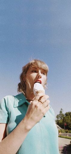 a woman is eating an ice cream cone