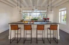 a kitchen with two bar stools and an island in the middle of the room