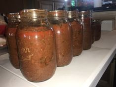 several jars filled with food sitting on top of a counter