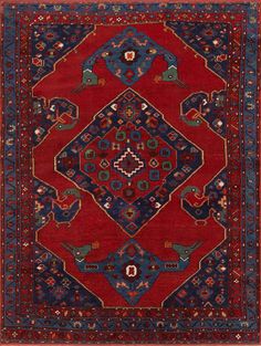 a red and blue rug with an intricate design