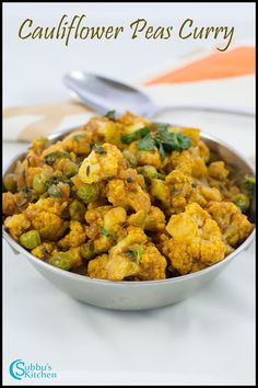 cauliflower peas curry in a silver bowl with spoons on the side and text overlay