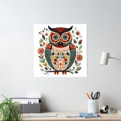 an owl sitting on top of a wooden desk next to a potted green plant