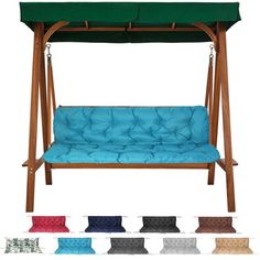 a wooden swing bed with blue cushions and green canopy over the top, all in different colors