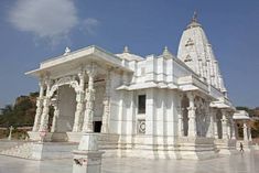 an ornate white building with pillars and arches