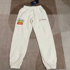 Nwt Madhappy X Pixar Toy Story Cream Sweatpants Sz: Small (S) *Sweatpants Has A Tiny Stain* Nmh02 Playful White Bottoms With Pockets, Playful White Pants For Loungewear, Playful White Bottoms For Loungewear, Playful White Loungewear Bottoms, Light Blue Sweatpants, Cream Sweatpants, Mad Happy, Brown Sweatpants, Happy Logo