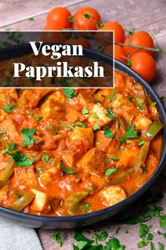 vegan paprikash in a bowl with tomatoes and parsley on the side