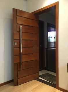 an open wooden door in the middle of a room