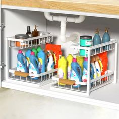 two white shelves filled with different types of cleaning products