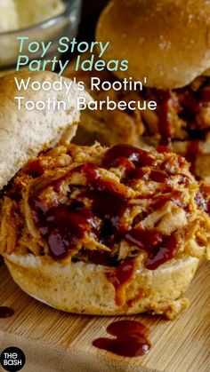 a bbq sandwich on a wooden cutting board with the words woody's rootin'toolin'barbecue