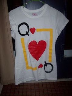 a t - shirt with the word q on it hanging from a clothes hanger