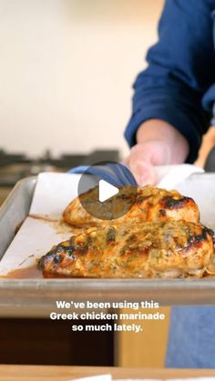 a person cutting up food on top of a pan