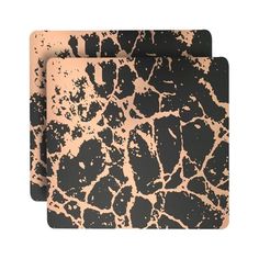 two black and gold coasters on a white background, each with a giraffe print