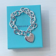 Authentic, Return To Tiffany Collection, Heart Lock Bracelet. A Beautiful Statement Piece! Sterling Silver Link Bracelet. Each Link Measures At .50" Wide. Heart Locket Measures At Approx. .75". The Hallmark Is Stamped On 2 Links, In Addition To The Heart Locket (See Pics). Brand New, Never Worn. Includes Original Box, Velvet Pouch, & Cream Ribbon. The Return To Tiffany Collection Is A Classic. Bold Yet Elegant, This Bracelet Is A Timeless Design. Sterling Silver Size Large 7.75" Long Luxury Silver Bracelets For Valentine's Day, Luxury White Gold Heart Bracelet, Luxury Heart Cut Silver Bracelet, Luxury Sterling Silver Heart Bracelet For Valentine's Day, Luxury Silver Heart Bracelet For Valentine's Day, Luxury Silver Heart Cut Bracelet, Luxury Heart Bracelet For Wedding, Luxury Heart-shaped Bracelet For Wedding, Luxury Wedding Heart Bracelet With Heart Charm