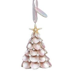 a pink christmas tree ornament hanging from a string on a white background with starfish