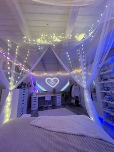 a bedroom decorated in white and blue lights