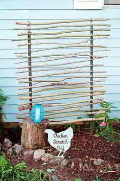 a wooden fence made out of sticks with a sign next to it