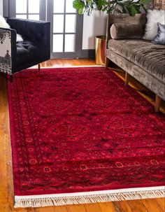 a living room with couches and a rug