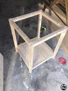 a wooden box sitting on top of a cement floor