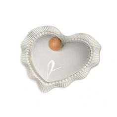 a heart shaped plate with an egg in it