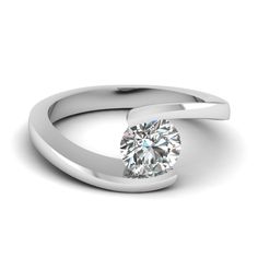 a white gold ring with a round cut diamond