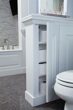 a white toilet sitting next to a bath tub