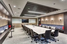 an empty conference room with long tables and chairs