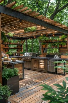 an outdoor kitchen with grill, sink and potted plants on the counter top under a pergolated roof