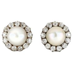 Victorian natural pearl and diamond cluster earrings. A matching pair, set to centre with a round natural saltwater pearl in a half-drilled open back setting, two in total, approximately 8.4mm each in diameter, encircled by thirteen cushion shape old mine diamonds in open back claw and grain settings, twenty-six in total with a combined approximate weight of 2.60 carats, to an impressive pair of cluster earrings, featuring curving claws, intricately pierced galleries and open backholing, fitted Antique Diamond Earrings, Art Deco Drop Earrings, Pearl Earrings Designs, Pearl Cluster Earrings, Oxidized Silver Earrings, Natural Pearl Earrings, Diamond Cluster Earrings, Platinum Earrings, Saltwater Pearls