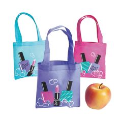 three bags with different designs on them, one has an apple and the other has lipstick