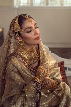 a woman in a bridal outfit sitting down