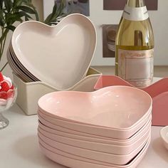 there are many heart shaped dishes on the table