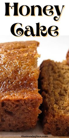 two pieces of cake sitting on top of a cutting board next to the words honey cake