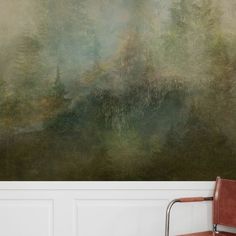 a chair sitting in front of a wall with a painting on it's side