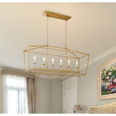 a chandelier hanging over a bed in a room with white walls and curtains