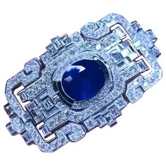 An exclusive Brooch/Pendant in Art Deco design, so elegant and refined, a very piece of art. Brooch/Pendant come in 18k gold , with a natural Royal Blue Ceylon Sapphire, in perfect oval cut , extra fine quality, of 6,76 carats, and 148 pieces of sparkly natural diamonds of 3,70 carats, F/ VS clarity , in round and baguettes cut. This piece you can use as a brooch and as a pendant, so you have two jewels in one piece. It is a piece of high jewelry. Handcrafted by artisan goldsmith. Excellent manu Diamond Gemstone Brooches In Art Deco Style, Art Deco Diamond Brooches With Gemstone, Luxury Platinum Brooches, Elegant Sapphire Brooches For Formal Occasions, Ceylon Sapphire, Diamond Brooch, Art Deco Design, High Jewelry, Oval Cut