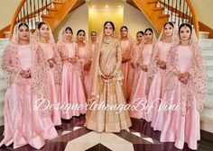 a group of women in pink dresses standing next to each other