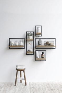 a white wall with some shelves on it