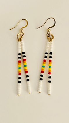 Seed bead earrings/Beaded earrings/Southwest long Beaded earrings/boho earrings/minimalist earrings/western earrings Items Details: Handmade Made to order 2 1/4" long White and Black seed beads, orange, red,yellow and turquoise.  Nickel free ear hook with rubber backs.  New Handmade western earrings. Make a statement with these minimalist style earrings.  Boho earrings.  All Items are created in my smoke free studio. Shipping: Items are shipped US mail and comes with a tracking # and ships in a cardboard box for safe shipping or shipping mailer. Thank you for browsing in my shop if you like my creations please favorite my shop and come back again. I frequently add new items weekly.  Thanks again have a nice day !!     C1C Handmade Minimalist Beaded Dangle Earrings, Southwestern Style White Beaded Dangle Earrings, Minimalist Handmade Beaded Dangle Earrings, Minimalist White Beaded Dangle Earrings, Minimalist Beaded Dangle Earrings, White Everyday Earrings With Colorful Beads, Minimalist White Beaded Drop Earrings, Everyday White Earrings With Colorful Beads, Southwestern Tiny Beads Dangle Earrings