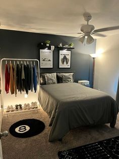 a bed room with a neatly made bed and pictures on the wall