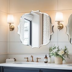 a bathroom with two sinks and a large mirror on the wall above it's sink