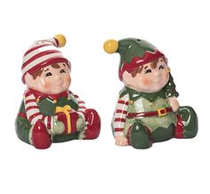 two ceramic christmas figurines sitting next to each other on a white background,