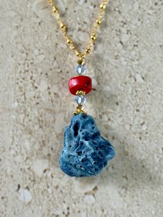 Natural Blue Coral pendant accented with a red coral rondelle shape bead and 6MM light sapphire blue Swarovski crystal and gold pyrite rosary chain.  Handmade GIFT BOXED Red Faceted Beads Jewelry For Beach, Handmade Red Coral Jewelry For The Beach, Blue Gemstone Jewelry For The Beach, Faceted Red Coral Beads Jewelry Gift, Coral Faceted Beads Jewelry For Gifts, Coral Faceted Beads Jewelry As Gift, Unique Coral Jewelry For Beach, Spiritual Beach Jewelry With Faceted Beads, Spiritual Faceted Beads Jewelry For Beach