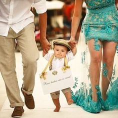 a man and woman walking down a runway with a small child in front of them