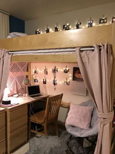 a loft bed with a desk and chair underneath it, surrounded by string lights on the wall