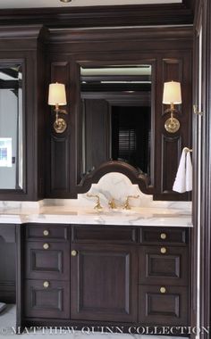 a bathroom vanity with two sinks and mirrors