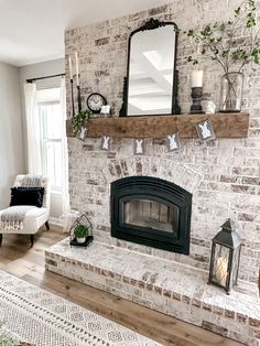 a living room with a brick fireplace and mirror