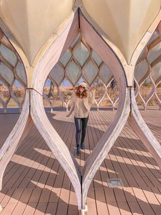 a woman is standing in front of a sculpture