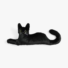 a black cat stuffed animal laying on its back