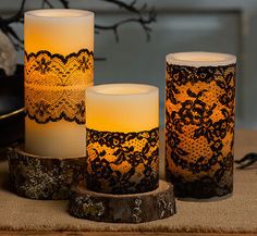 three candles sitting on top of a table next to a skull