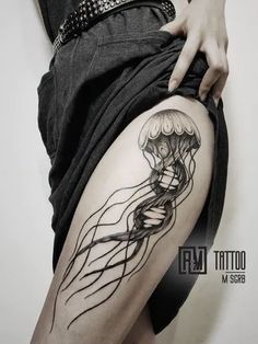 a woman's thigh with a tattoo of a jellyfish